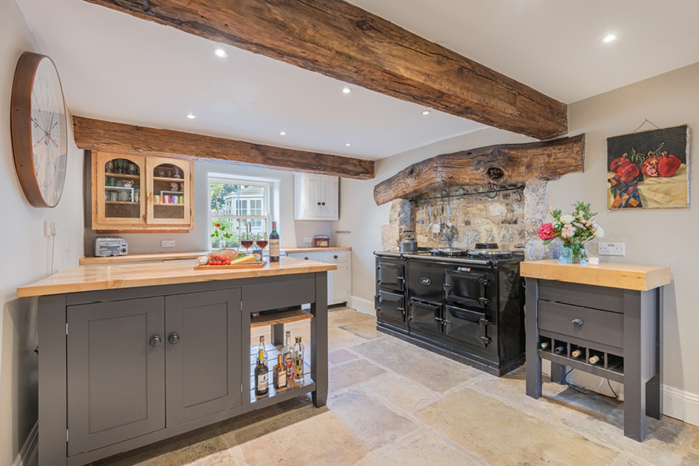 Farmhouse kitchen with exposed beams and range