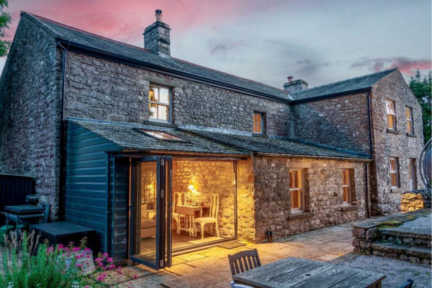 Rear of the stone Farmhouse with Bi-folding door onto a patio