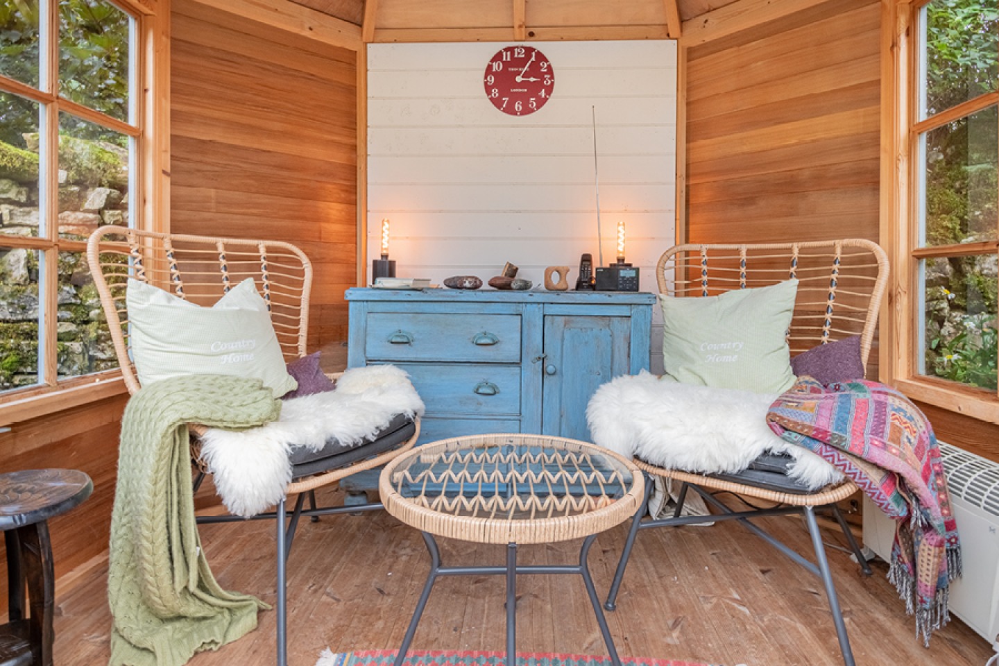 interior of summer house wicker chairs and cosy blankets and pillows